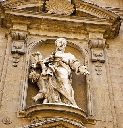 Ancient statue on the facade of a church in florence italyの写真素材