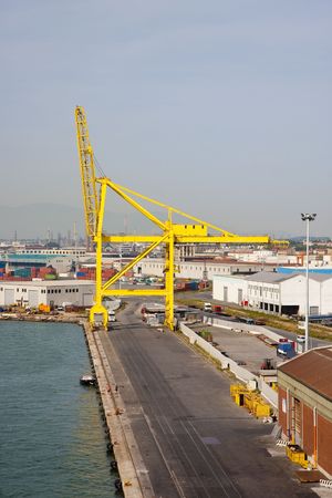 A large yellow harbor crane at a shipping portの写真素材