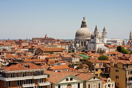 Famous church domes in venice italy shot over the red tile roofsの写真素材