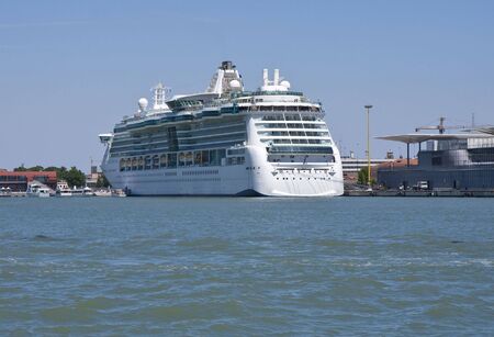 A massive luxury cruise ship tied to a dockの写真素材