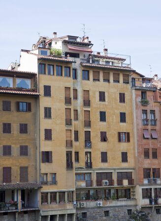 Old arpartment buildings along the arno river in florence italyの写真素材