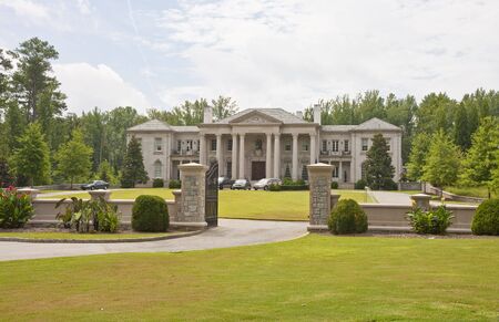 A large mansion on a well landscaped lotの写真素材