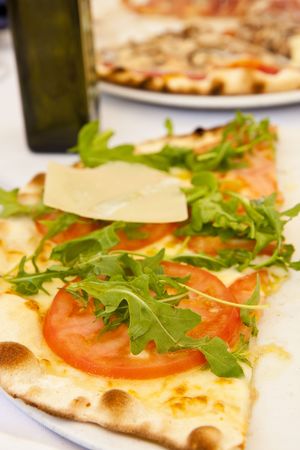 A traditional fresh Italian pizza with tomato, basil, and mozzarellaの写真素材