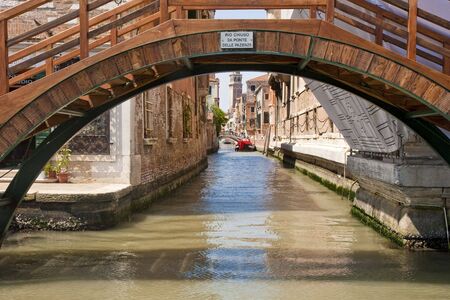 A view of a venice canal from under  a bridgeの写真素材