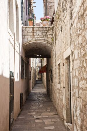 A narrow cobblestoned alley through the old town of Dubrovnikの写真素材