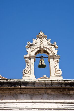 An ancient bell on the roof of a building in old Dubrovnik Croatiaの写真素材