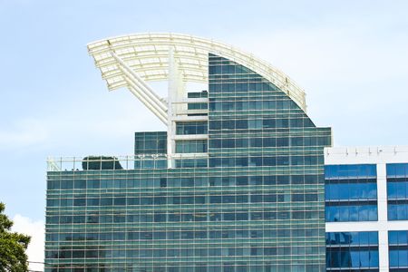 A modern office building with a curved retractable roofの写真素材
