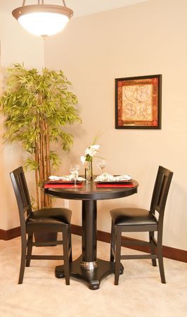 A small black table set for two people in the corner by bambooの写真素材