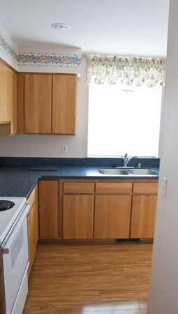 A small modern kitchen in a condominium or apartmentの写真素材
