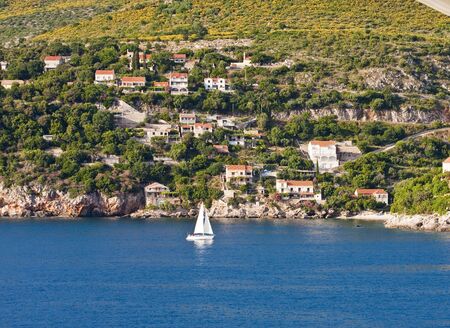 White Sailboat off the Coast of Dubrovnik Croatiaの写真素材