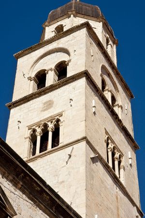 An ancient bell tower in Croatia Against a Blue Skyの写真素材