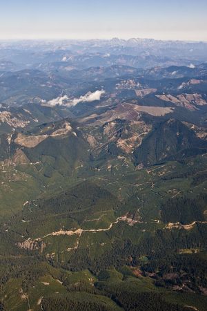 Green and snow capped mountains to the horizonの写真素材