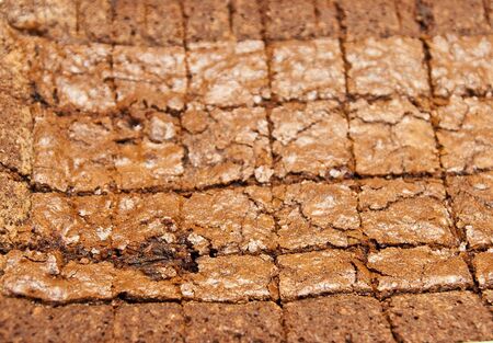 Fresh, hot, chocolate brownies cut for servingの写真素材