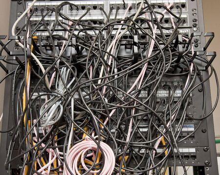 Telephone patch panel with tangled telephone cordsの写真素材