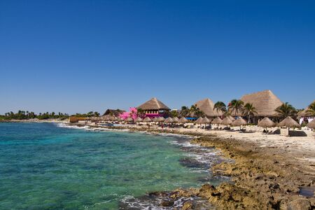 Colorful huts on a rocky beach in Mexicoの写真素材