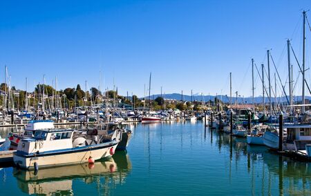 A channel into a marina on calm waterの写真素材