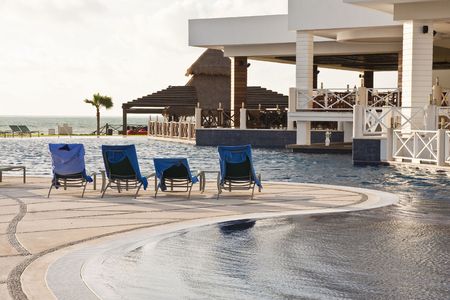 A luxury resort swimming pool in early morning lightの写真素材