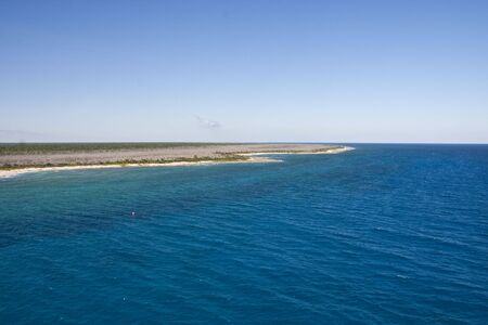 A finger of flat land in an azure blue seaの写真素材