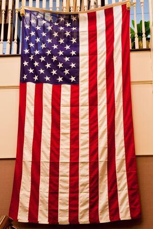 An American flag hanging on a staircase banisterの写真素材