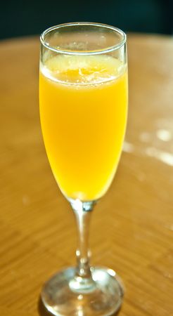A cold glass of fresh squeezed orange juice on a wood tableの写真素材