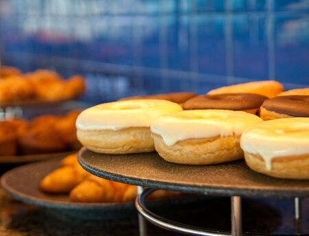 A tray of delicious donuts on a tray of a buffetの写真素材