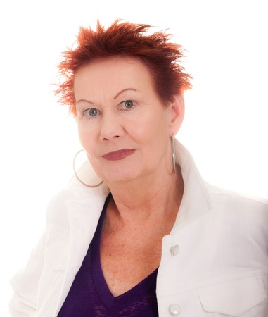 A woman in her sixties with a modern hair style and clothes on a white backgroundの写真素材