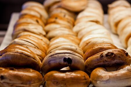 Fresh blueberry bagels in a bakery caseの写真素材