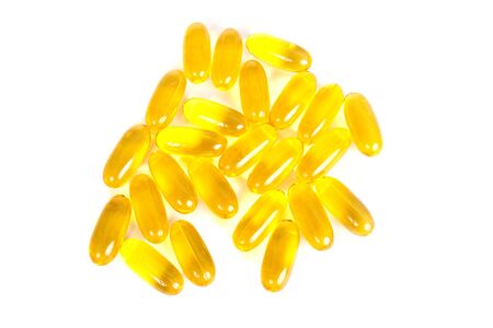 Yellow gel caps on a white backgroundの写真素材