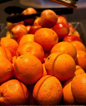 Fresh oranges and apples on a fruit buffetの写真素材