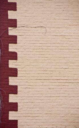 An old white brick building with a red brick cornerの写真素材