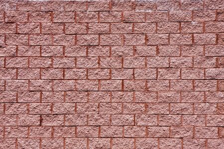 An old brick wall of textured red brick for backgroundの写真素材