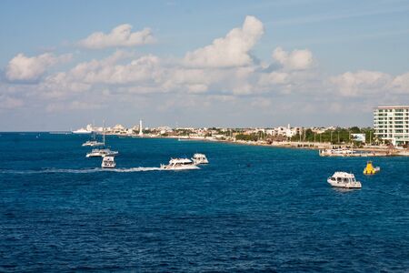 White boats speeding through blue water off the coast of Cozumel Mexicoの写真素材