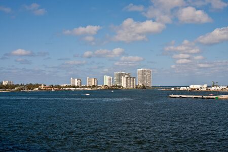 White modern condo buildings along a shipping channelの写真素材