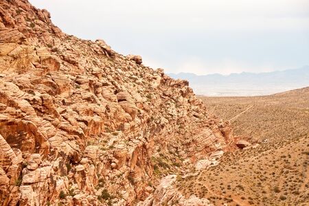 Rockiy Hills in Red Rock Canyon descending toward stormy skiesの写真素材