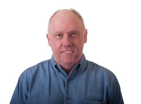 A nice friendly looking older man in a blue denim shirtの写真素材
