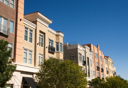 Modern stucco lofts under a clear blue skyの写真素材