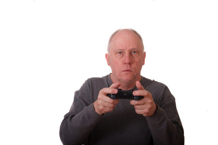 An older man playing a video game with a wireless controller