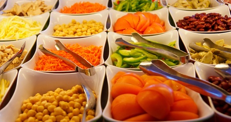 Many colorful vegetables on a salad barの写真素材