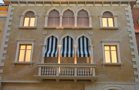 Building in Venice at Dusk with Green and White Awningsの写真素材