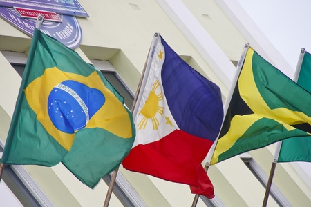 Yellow building with international flagsの写真素材