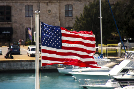 American flag flying at marina at Old Naval Dockyard in Bermudaの写真素材