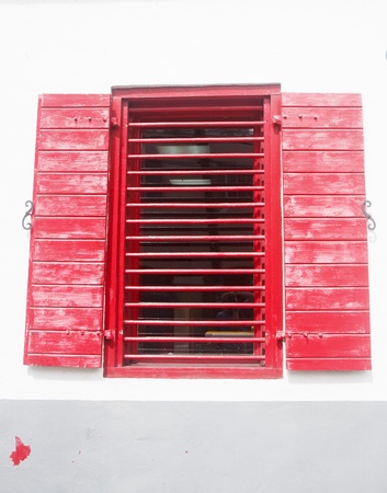 A window in a white and grey wall painted redの写真素材
