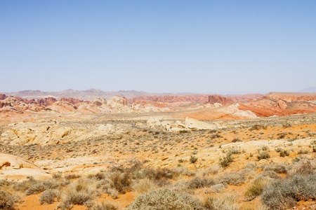 A highway curving through the distance in a colorful desert landscapeの写真素材