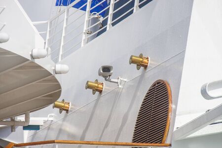 Polished brass fixtures on white bulkhead of a cruise shipの写真素材