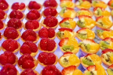 Many fruit tarts on a dessert buffetの写真素材