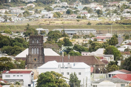 An old stone church among colorful buildings on St. Kittsの写真素材