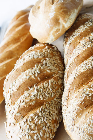 Several loaves of fresh bread garnished with seeds