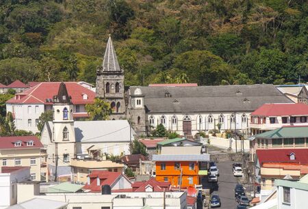 Colorful Buildings and an old stone church in the city of Rosseau, Dominicaの写真素材