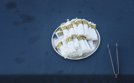 Cold towels on a tray with tongs on a hot dayの写真素材