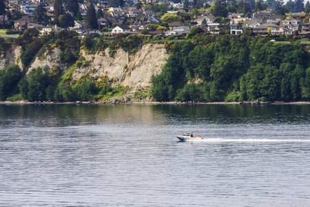 A small police boat speeding up the coast of Washington